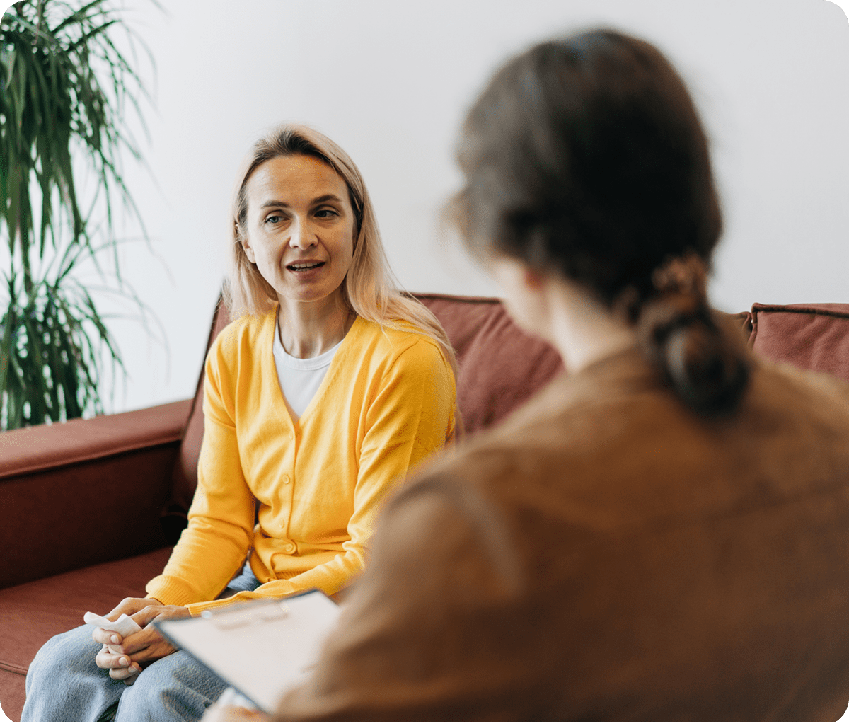 Two people having a conversation on sofa.