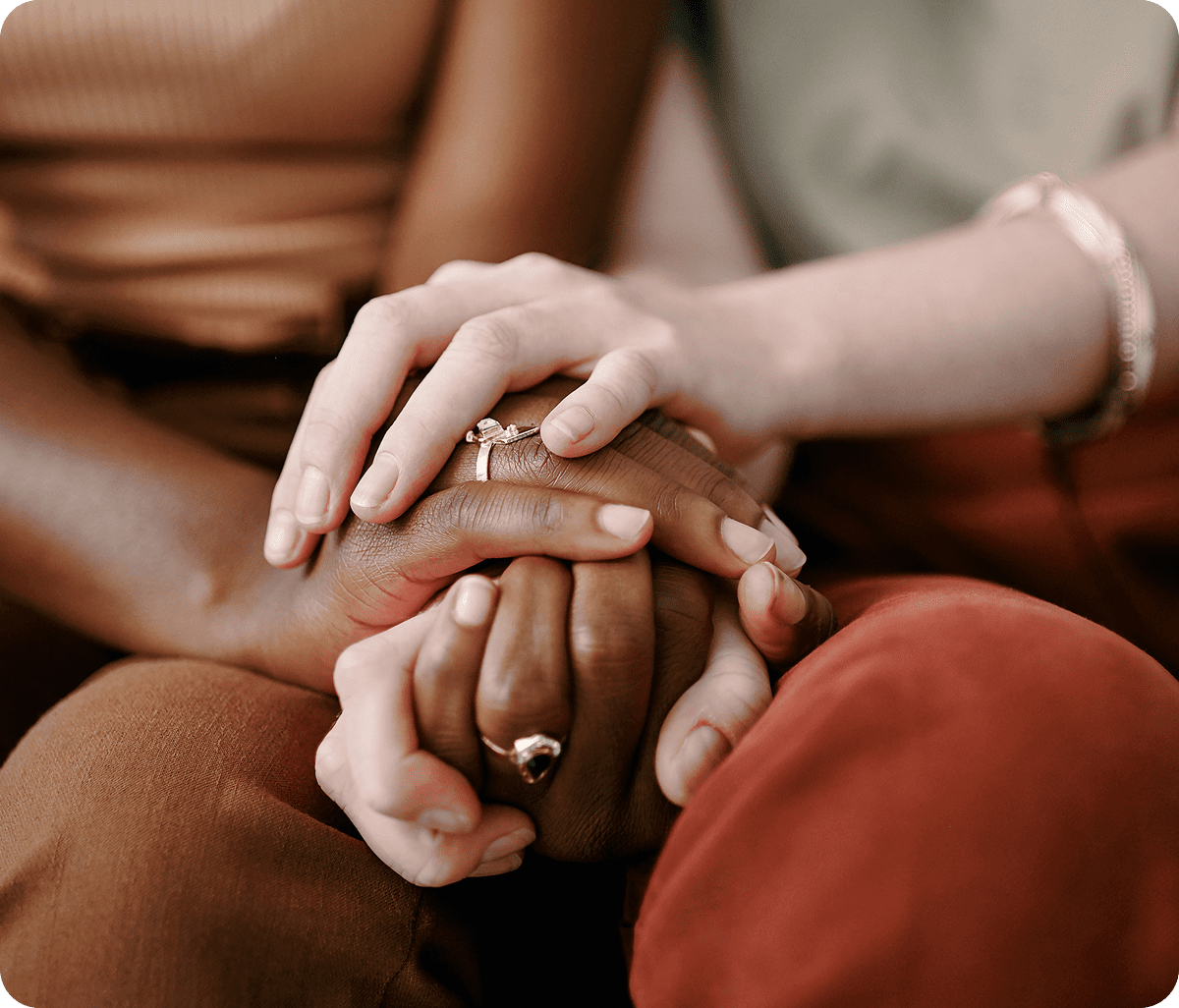 Hands holding each other in comforting gesture.